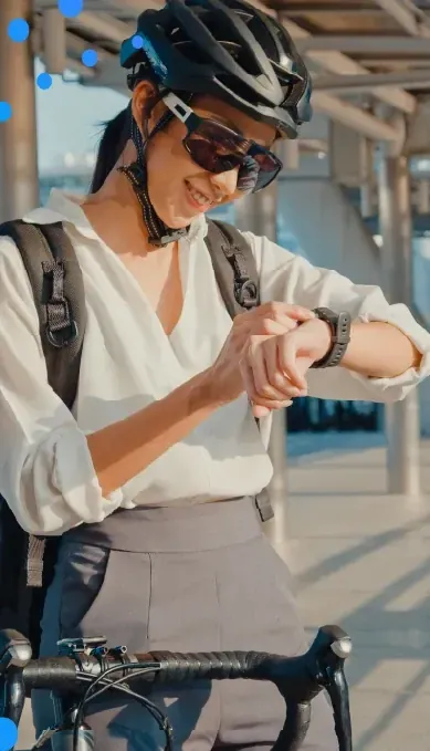 Cyclist in a helmet checking a smartwatch
